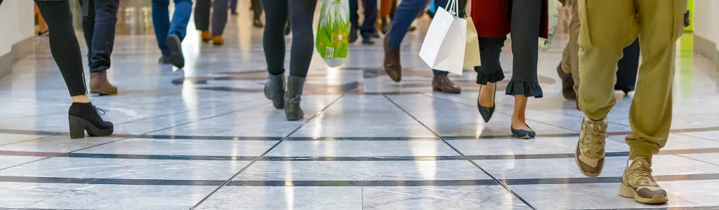 A modern floor with legs of a crowd in the background